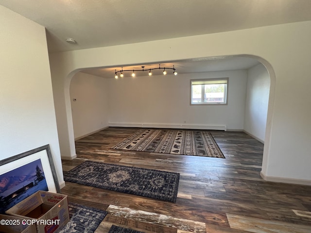 981 E Susitna Dr, Wasilla, AK 99654 - unfurnished room featuring arched walkways, wood finished floors, baseboards, and a smoke detector
