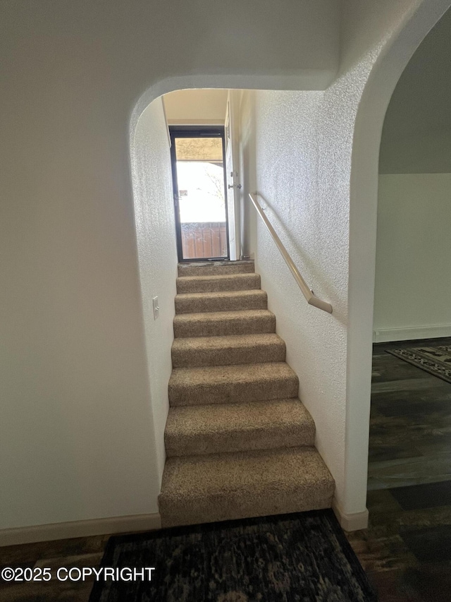 981 E Susitna Dr, Wasilla, AK 99654 - stairway featuring arched walkways, wood finished floors, and baseboards