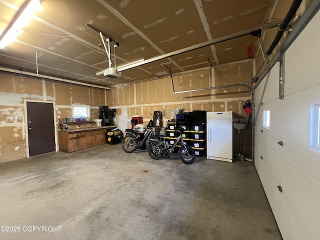 981 E Susitna Dr, Wasilla, AK 99654 - garage featuring a garage door opener and freestanding refrigerator