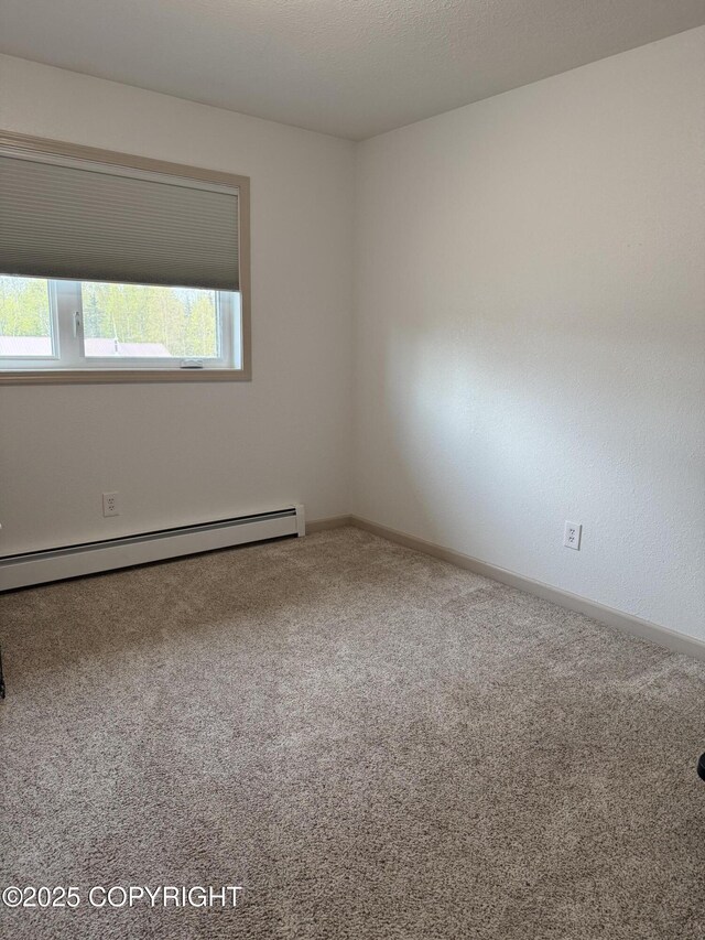 981 E Susitna Dr, Wasilla, AK 99654 - spare room featuring a baseboard heating unit, carpet floors, and baseboards