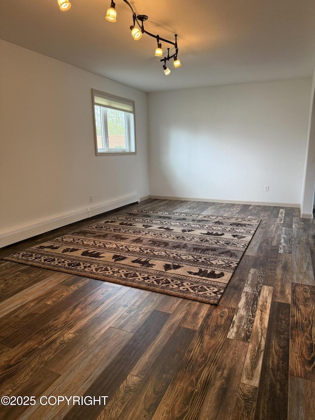 981 E Susitna Dr, Wasilla, AK 99654 - empty room with wood finished floors, baseboard heating, and baseboards