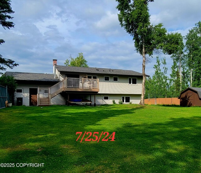 981 E Susitna Dr, Wasilla, AK 99654 - back of property with a wooden deck, stairs, a shed, and an outbuilding