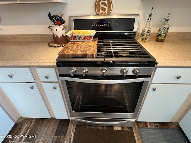 981 E Susitna Dr, Wasilla, AK 99654 - kitchen view of stainless steel gas range, light countertops, and dark wood-style floors
