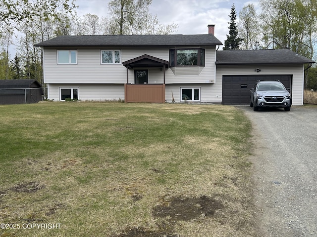 981 E Susitna Dr, Wasilla, AK 99654 - split foyer home with a garage, a chimney, asphalt driveway, and a front yard