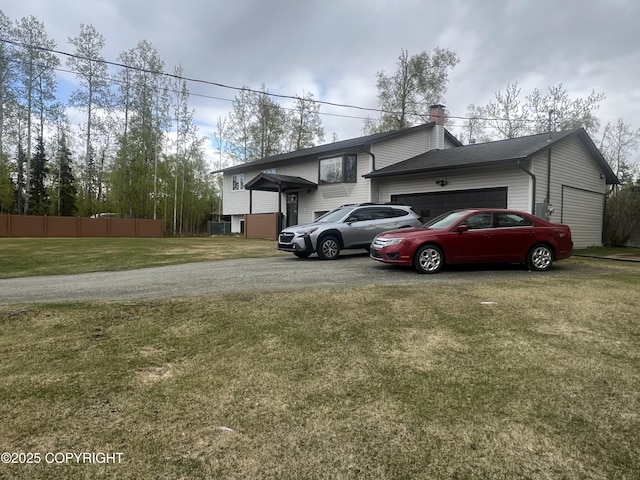 981 E Susitna Dr, Wasilla, AK 99654 - view of front facade with a garage, asphalt driveway, and a chimney