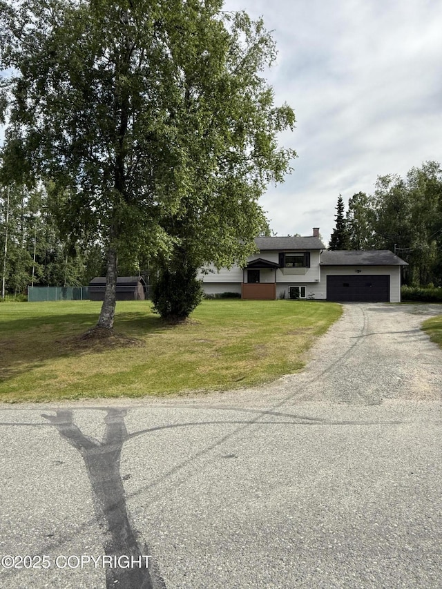 981 E Susitna Dr, Wasilla, AK 99654 - split level home featuring a garage, driveway, and a front yard