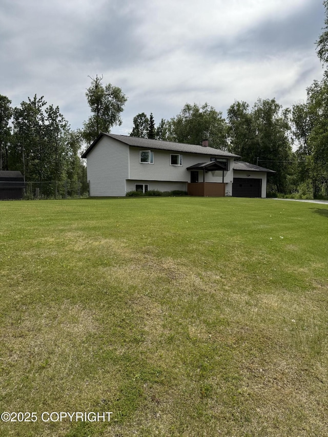 981 E Susitna Dr, Wasilla, AK 99654 - view of front of property with a front lawn, a garage, and a chimney