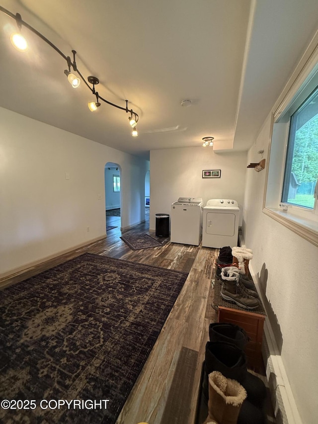 981 E Susitna Dr, Wasilla, AK 99654 - living area featuring separate washer and dryer, arched walkways, wood finished floors, and plenty of natural light