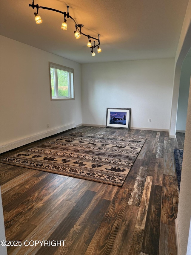 981 E Susitna Dr, Wasilla, AK 99654 - unfurnished living room with dark wood-type flooring and a baseboard heating unit