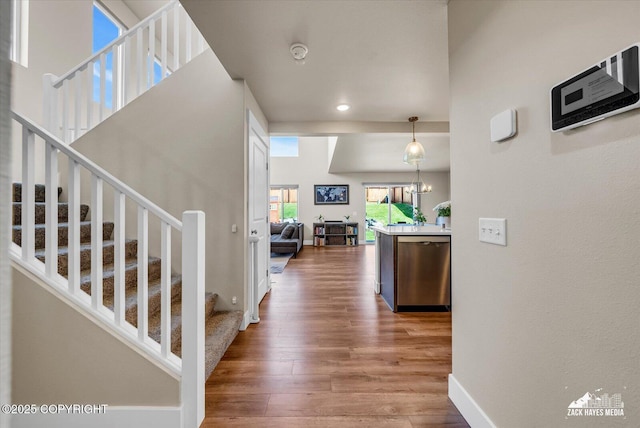 2945 Morgan Loop, Anchorage, AK 99516 - hall featuring wood finished floors, stairs, baseboards, and recessed lighting