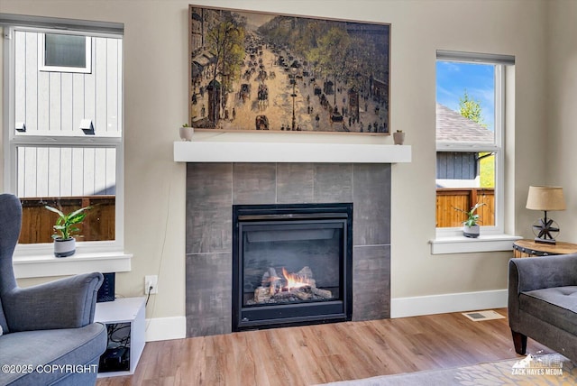 2945 Morgan Loop, Anchorage, AK 99516 - living area with baseboards, wood finished floors, and a tiled fireplace