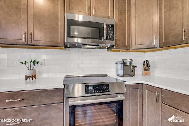 2945 Morgan Loop, Anchorage, AK 99516 - kitchen with stainless steel appliances, tasteful backsplash, and light countertops