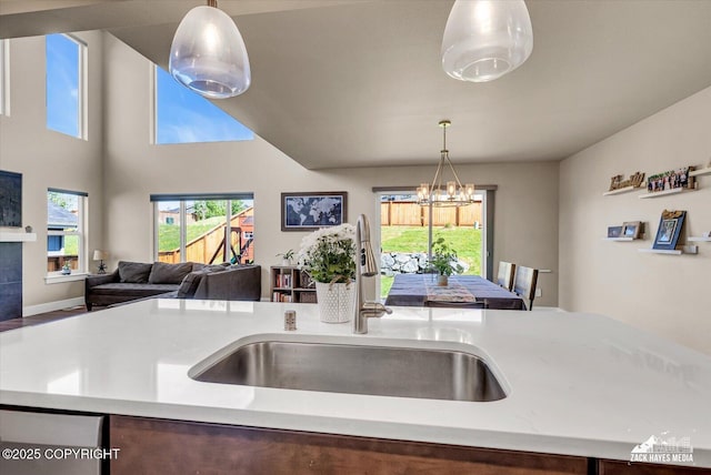 2945 Morgan Loop, Anchorage, AK 99516 - kitchen featuring a sink, open floor plan, light countertops, a chandelier, and decorative light fixtures