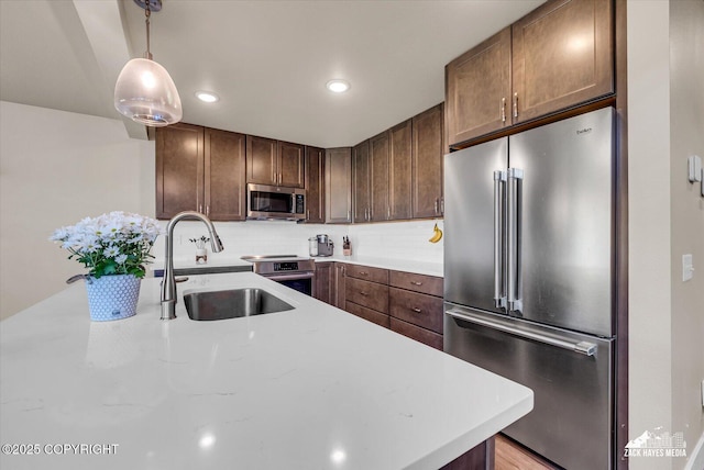 2945 Morgan Loop, Anchorage, AK 99516 - kitchen featuring appliances with stainless steel finishes, a sink, light countertops, backsplash, and recessed lighting