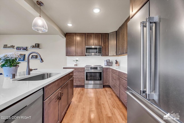 2945 Morgan Loop, Anchorage, AK 99516 - kitchen with appliances with stainless steel finishes, a sink, light countertops, light wood-type flooring, and tasteful backsplash