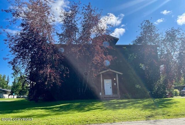obstructed view of property with a front yard