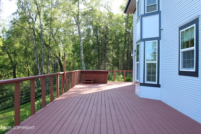 wooden deck featuring a hot tub