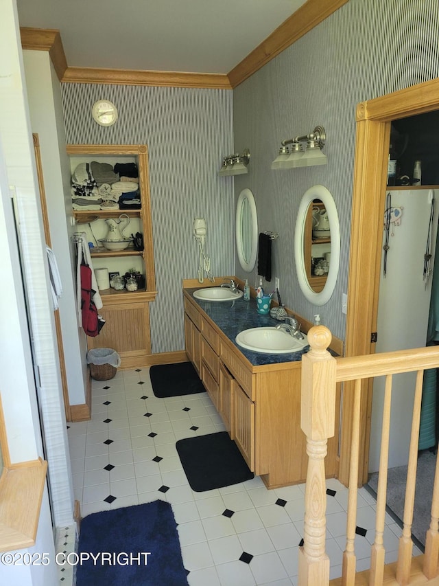 full bathroom featuring crown molding, tile patterned floors, wallpapered walls, and double vanity