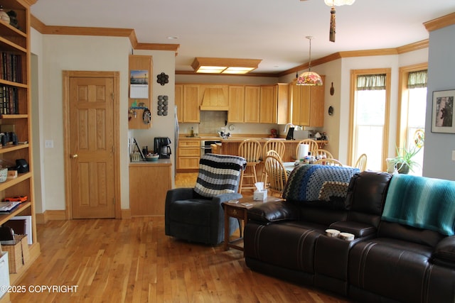 living area featuring light wood finished floors and ornamental molding