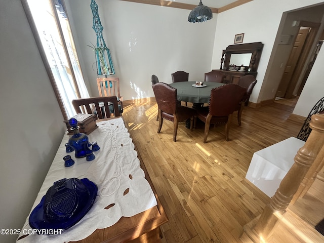dining area featuring wood finished floors and baseboards