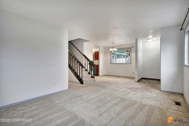 unfurnished living room featuring a chandelier, carpet floors, stairway, and baseboards