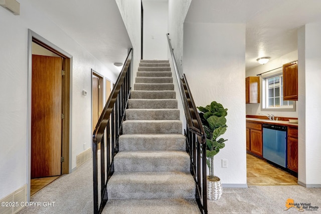 stairs featuring carpet and baseboards