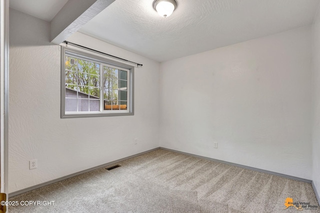 empty room featuring carpet floors and baseboards