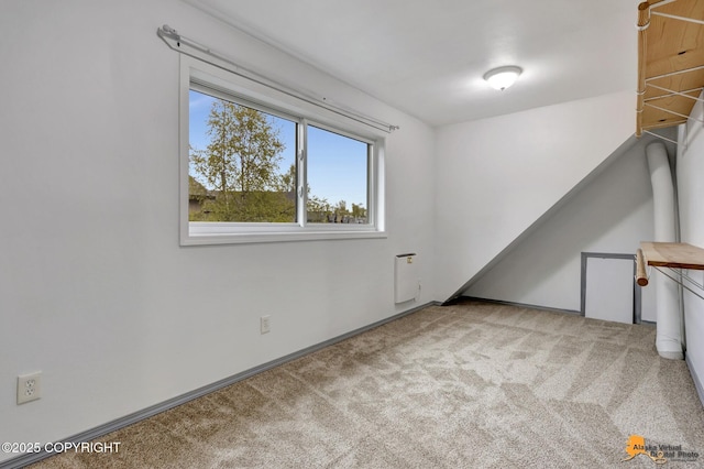 carpeted spare room featuring baseboards