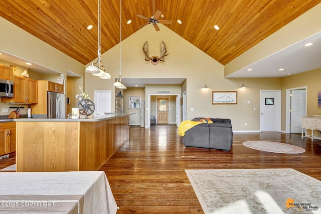 kitchen featuring stainless steel appliances, high vaulted ceiling, dark wood-style flooring, decorative light fixtures, and wood ceiling