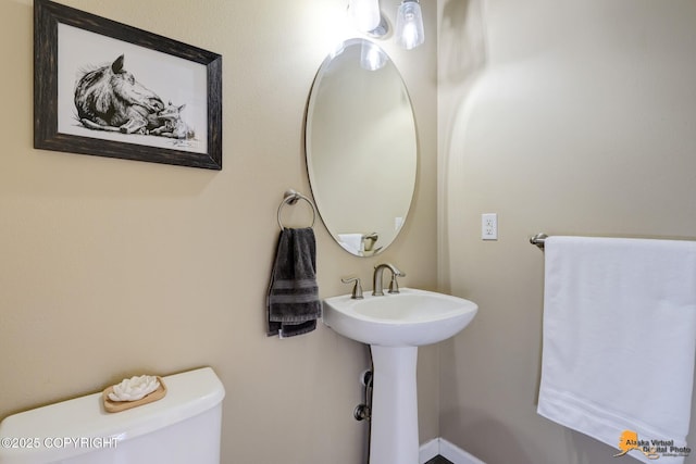 bathroom with toilet and a sink