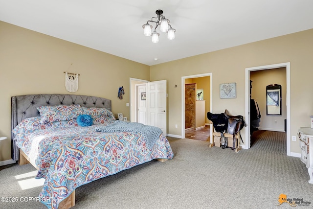 bedroom with a chandelier, carpet floors, a spacious closet, baseboards, and a closet