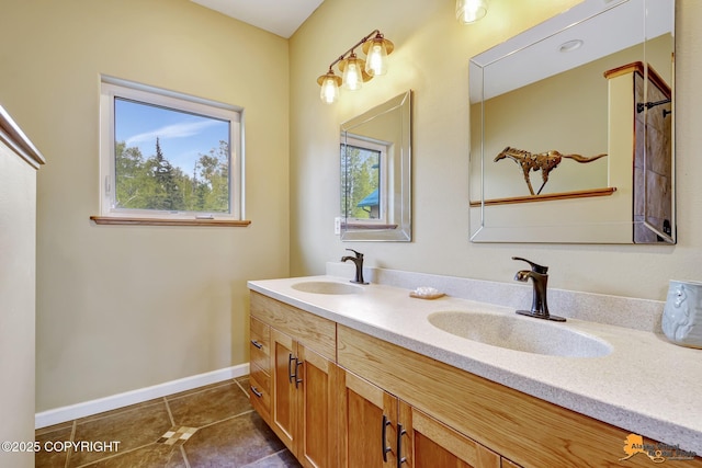 full bathroom with tile patterned flooring, double vanity, and baseboards