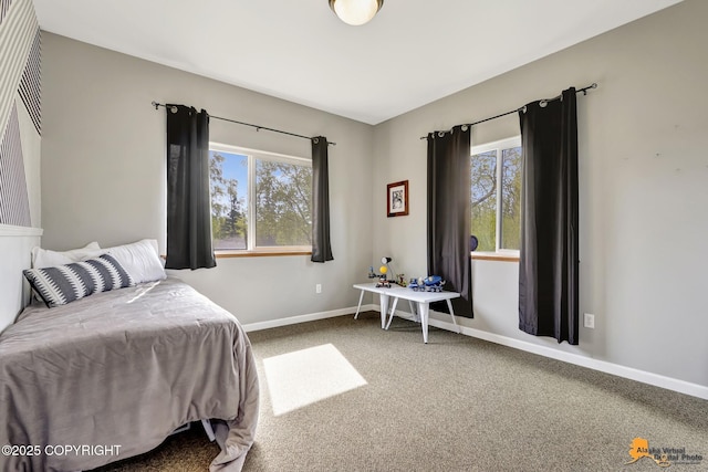 carpeted bedroom featuring multiple windows and baseboards