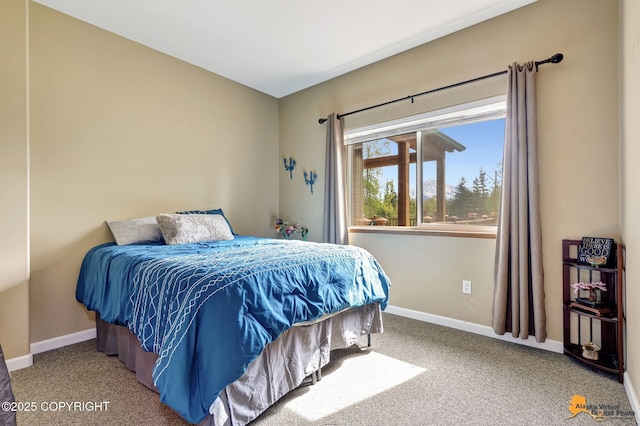 carpeted bedroom featuring baseboards