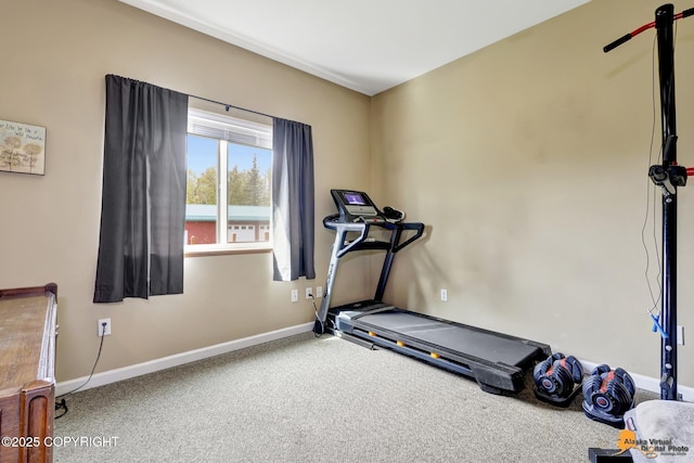 workout room featuring carpet floors and baseboards