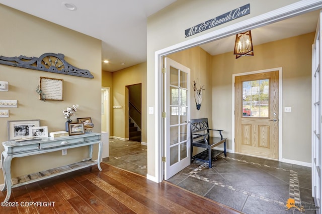 entrance foyer with baseboards, stairs, a chandelier, recessed lighting, and inlaid floor details