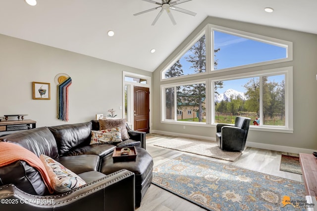 living room with high vaulted ceiling, a ceiling fan, recessed lighting, wood finished floors, and baseboards