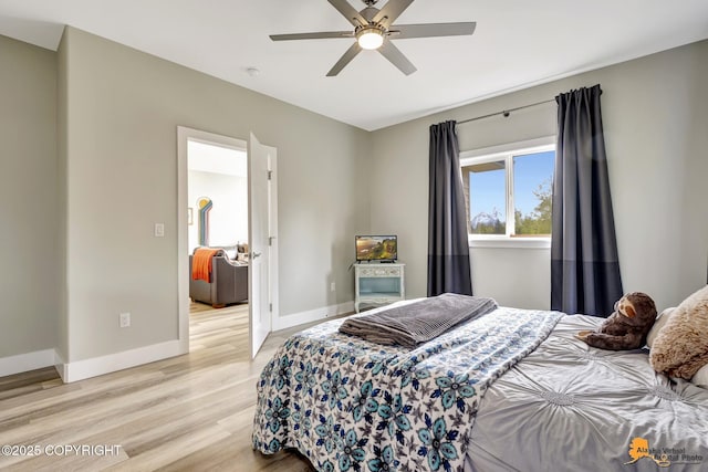 bedroom with light wood-style flooring, baseboards, and a ceiling fan
