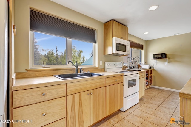 kitchen with white appliances, a sink, light countertops, light tile patterned flooring, and recessed lighting
