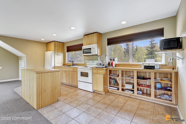 kitchen with white appliances, light brown cabinets, a sink, a center island, and recessed lighting
