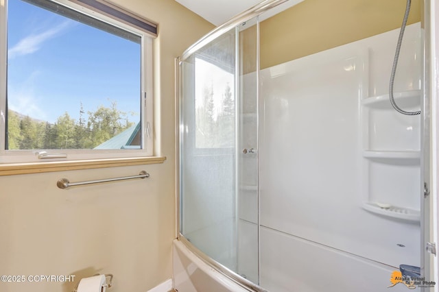 bathroom featuring bath / shower combo with glass door