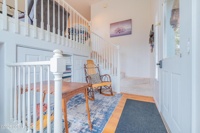 foyer with wood finished floors and stairway