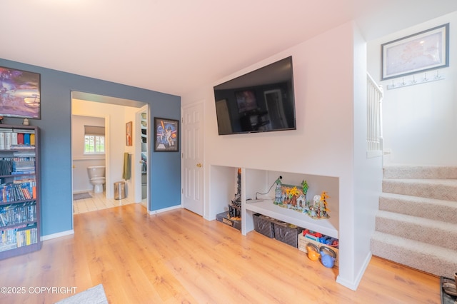 recreation room with wood finished floors and baseboards