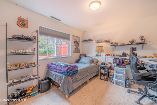 bedroom with a desk and carpet flooring