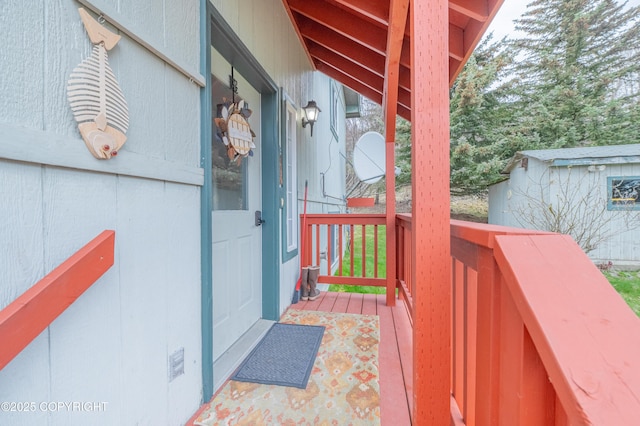 deck featuring a storage shed and an outbuilding