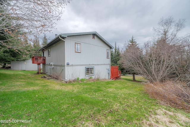 view of side of property with a lawn