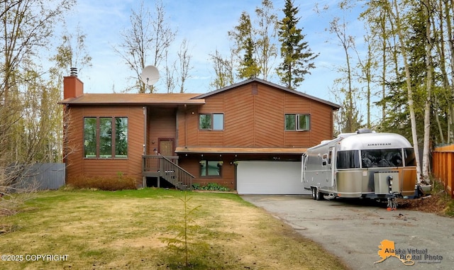 view of front of house with an attached garage, a chimney, and asphalt driveway
