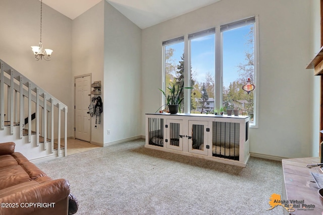 living area featuring a chandelier, carpet flooring, baseboards, stairs, and a high ceiling