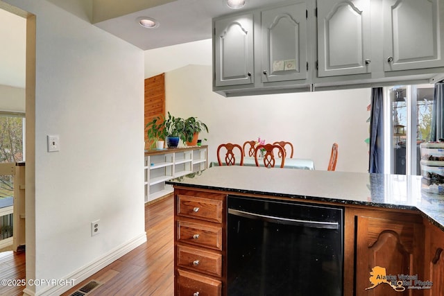 kitchen with dishwasher, light wood-type flooring, gray cabinetry, and baseboards