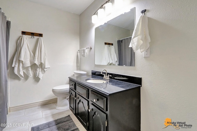 bathroom featuring vanity, toilet, baseboards, tile patterned floors, and a shower with shower curtain